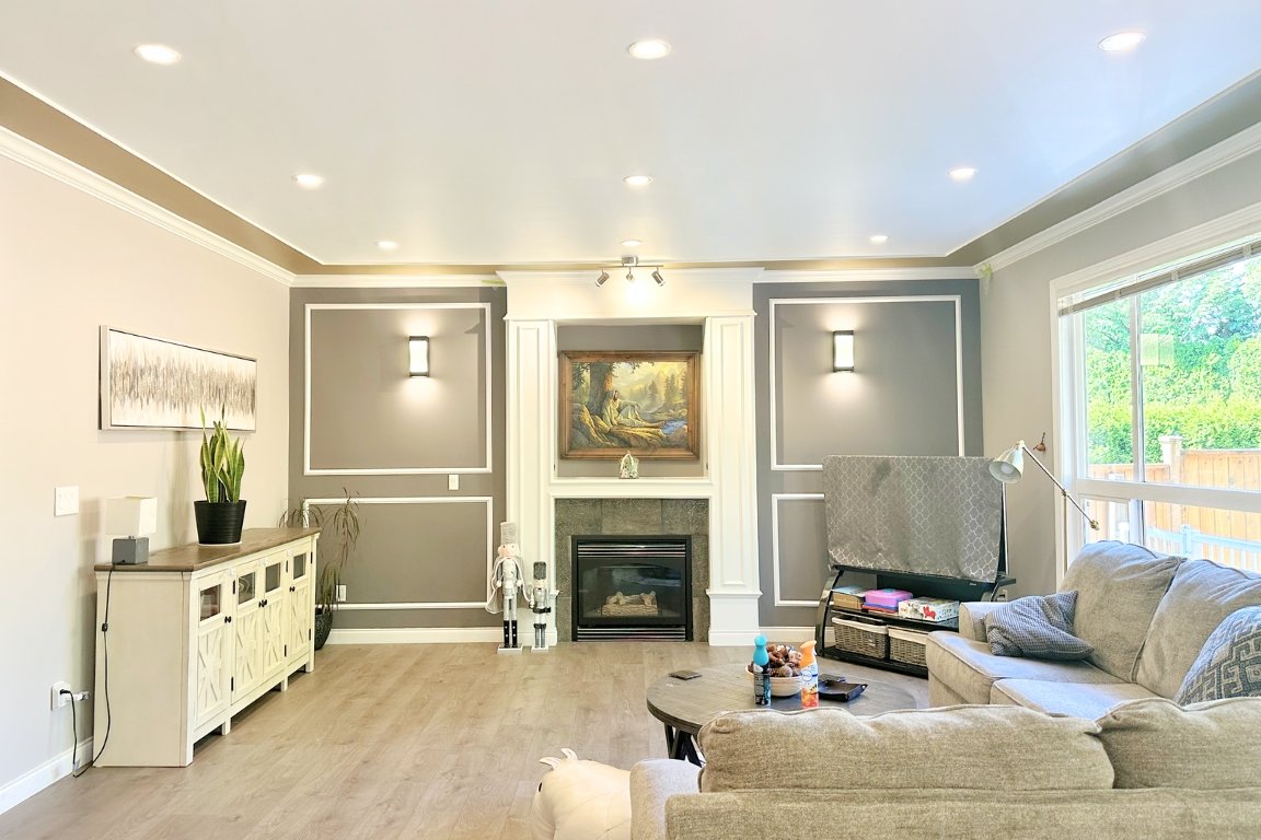 Basement transformation in home renovation in Langley, BC by Reno Stars, featuring a cozy family room with modern design elements and ample lighting