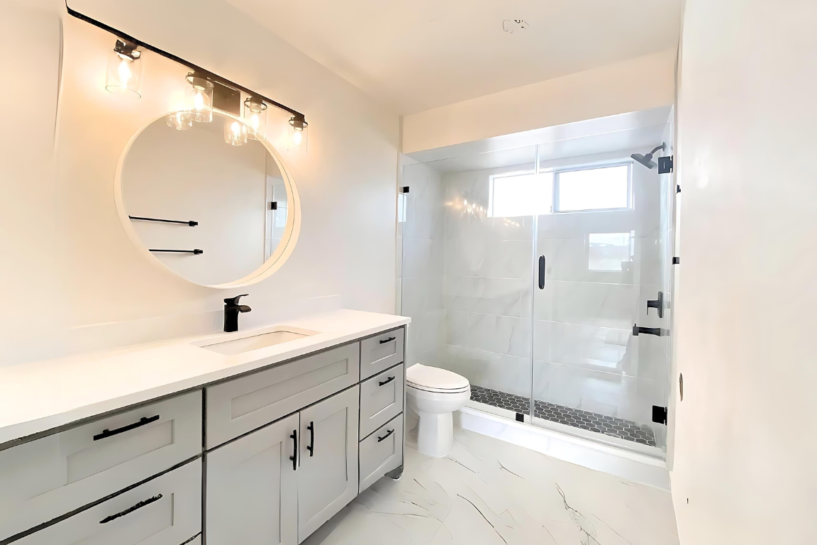 Modern bathroom renovation in Delta with a walk-in glass door shower, new vanity, and updated fixtures at Kitchen and Bathroom Renovation in Delta, BC