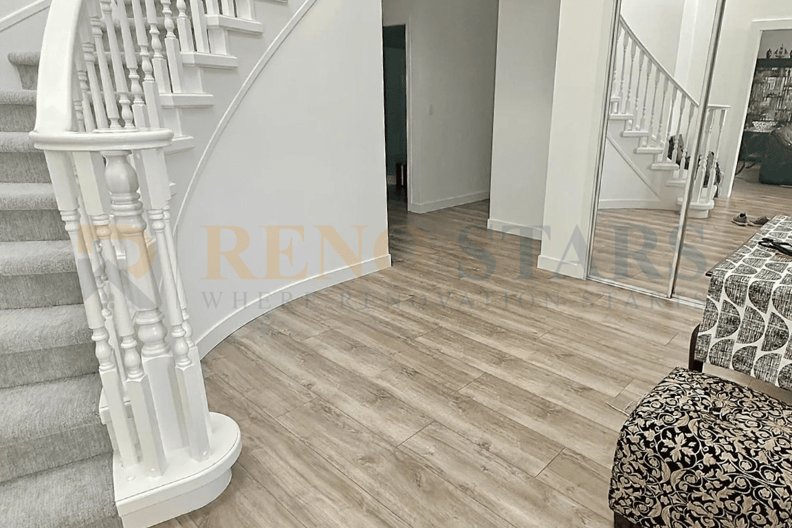 Modern staircase and entryway renovation in Richmond with refinished woodwork and SPC flooring