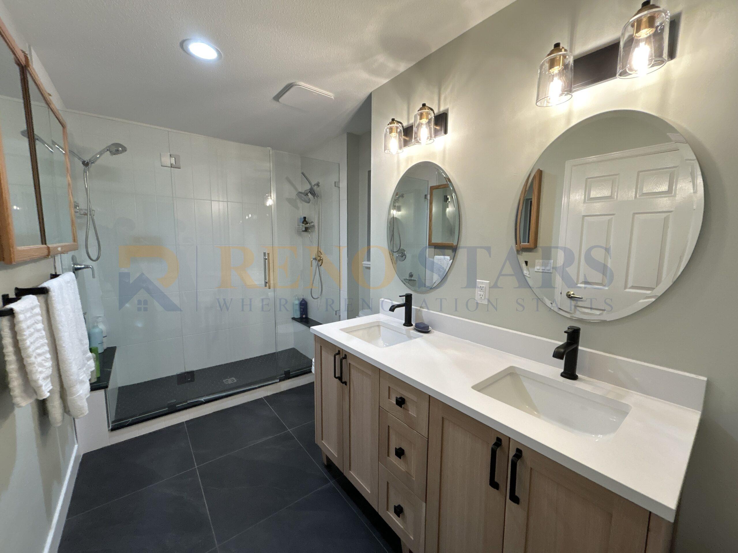 Modern bathroom with double vanity and glass shower enclosure.